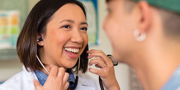 Student Health content module thumbnail SHS Doctor talks with student during appointment.